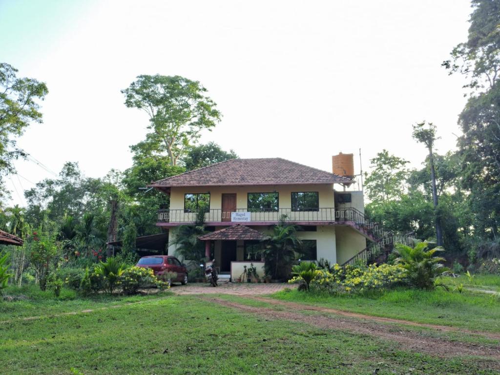 a house in the middle of a field at Magod Homestay in Idgundi