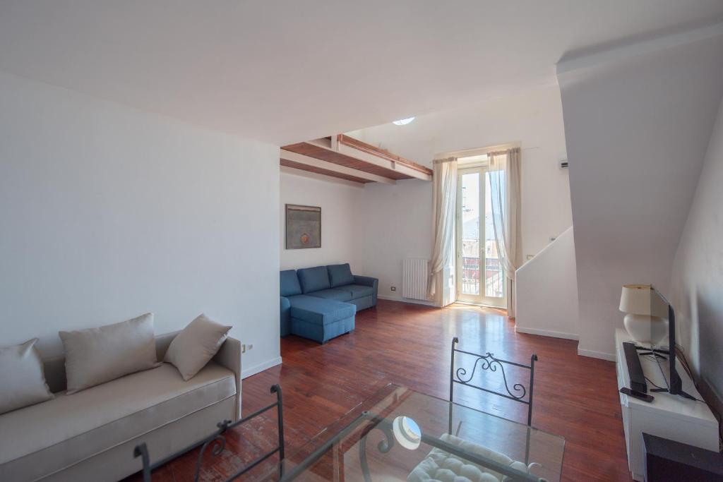 a living room with a couch and a glass table at Wellness HM al Corso By Dimorra in Naples