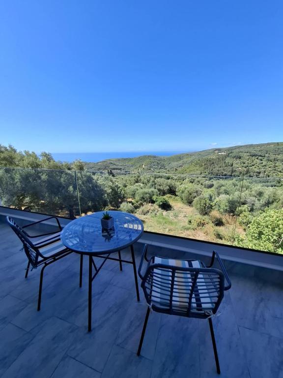 a table and chairs on a balcony with a view at Gaia Apartments Parga in Parga