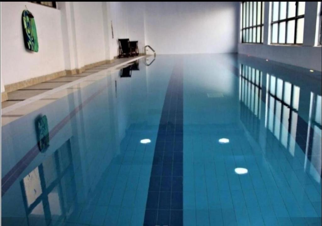 an empty swimming pool with a blue tile floor at Silver Habor Apartments , Kilimani in Nairobi