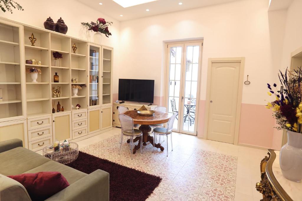 a living room with a table and a tv at At Home - Luxury apartment Bari in Bari