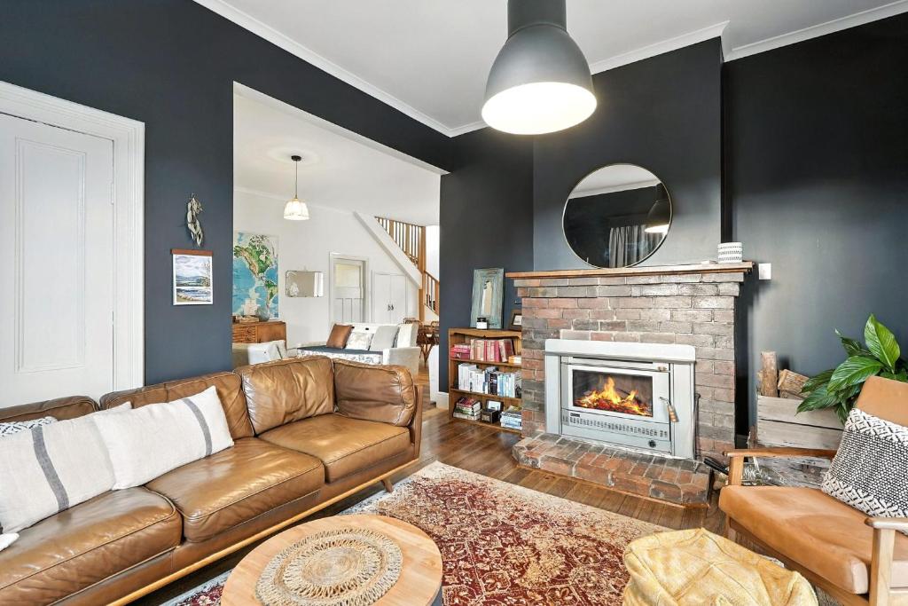 a living room with a couch and a fireplace at Countryside Escape Near Margate Village in Margate