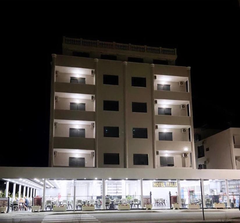 a large apartment building at night with a building at Hotel Italia in Golem