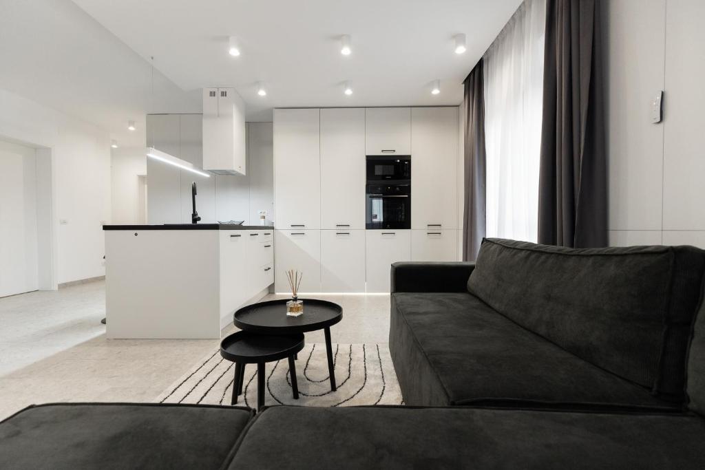 a living room with a couch and a table at Royalton Urbana in Oradea