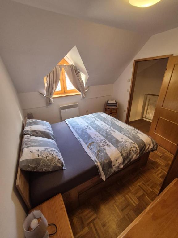 a bedroom with a large bed with a window at Marjetica 40 in Moravske-Toplice