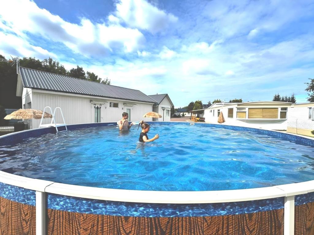 a group of people swimming in a large swimming pool at Zajazd Rest in Przemyśl