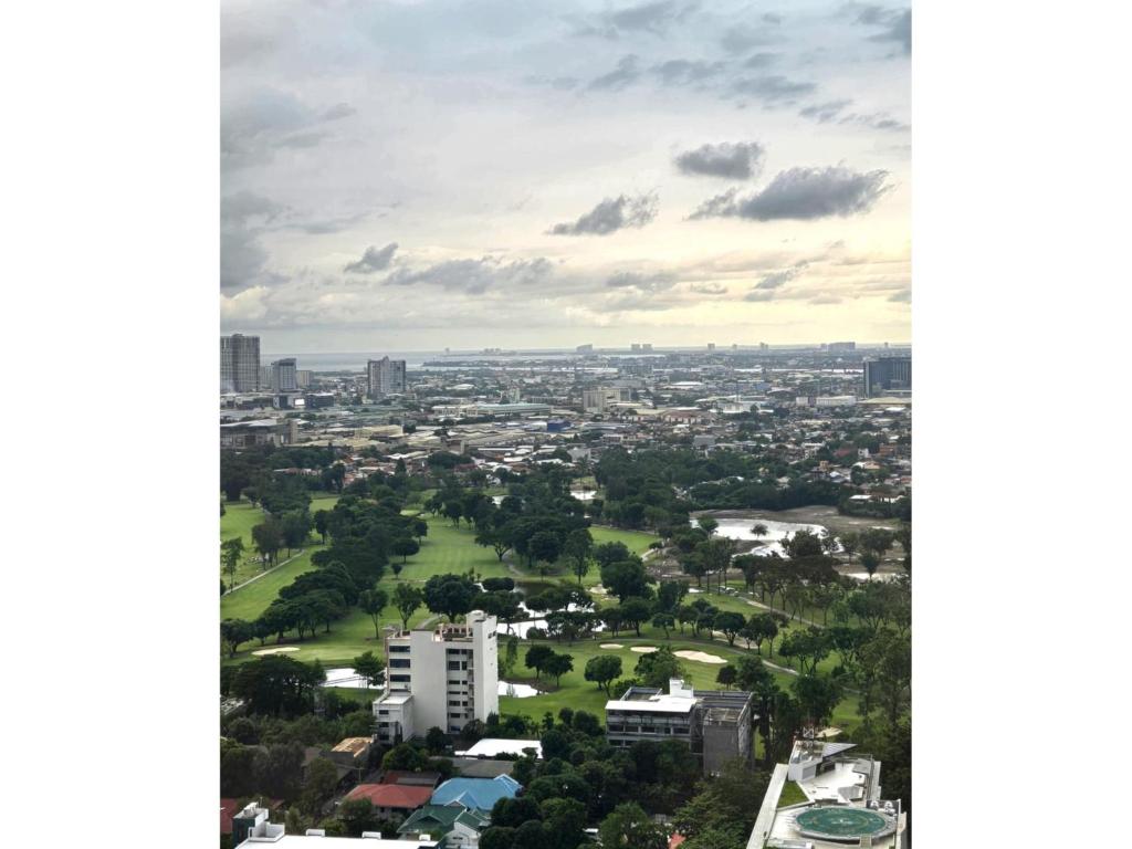 an aerial view of a city with buildings and trees at Studio With Citylights and SEAview near MALL inside IT PARK in Sampong
