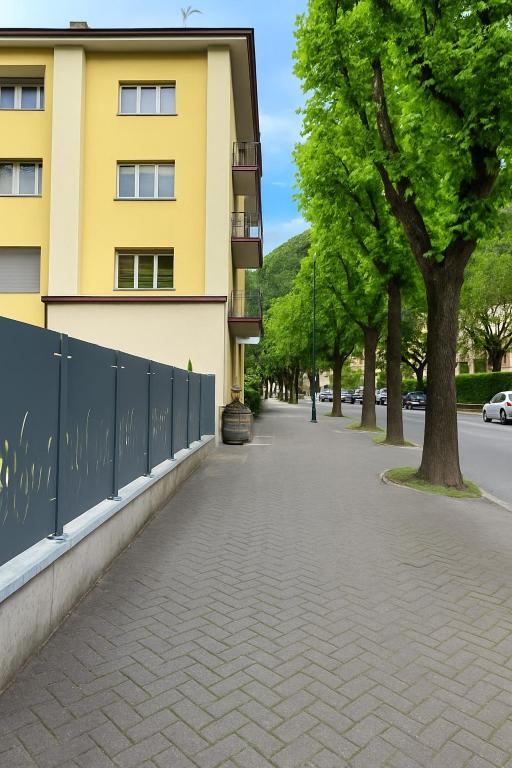 a sidewalk in front of a yellow building at Tirano center-325m dal Bernina Express in Tirano