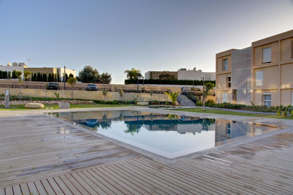 a swimming pool in the middle of a building at Appartement Taghazout Bay in Taghazout