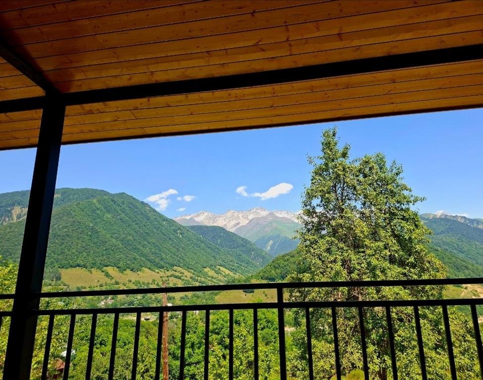 a view of a mountain range from a balcony at Datucha's guesthouse in Ghebi