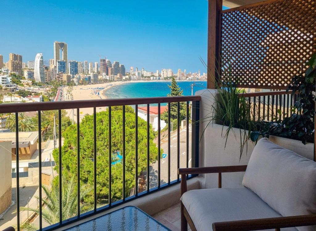 a balcony with a view of the beach and buildings at Nomad Boutique Resort Benidorm in Benidorm