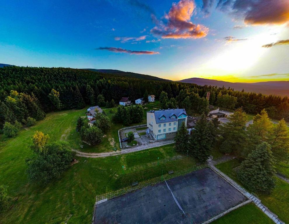 an aerial view of a house on a grassy field at Ośrodek Wypoczynkowy "Przy Lesie" in Karpacz