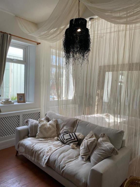 a white couch in a living room with a window at Hidden Gem in cullercoats in Cullercoats