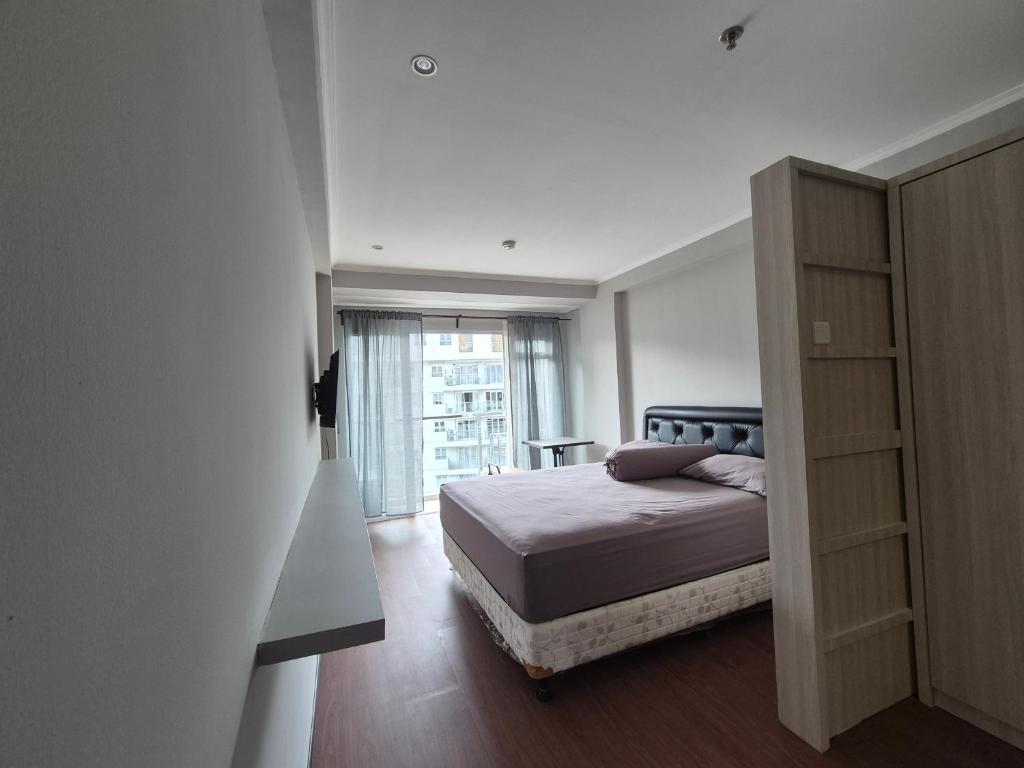 Ένα ή περισσότερα κρεβάτια σε δωμάτιο στο Apartemen Gateway Pasteur