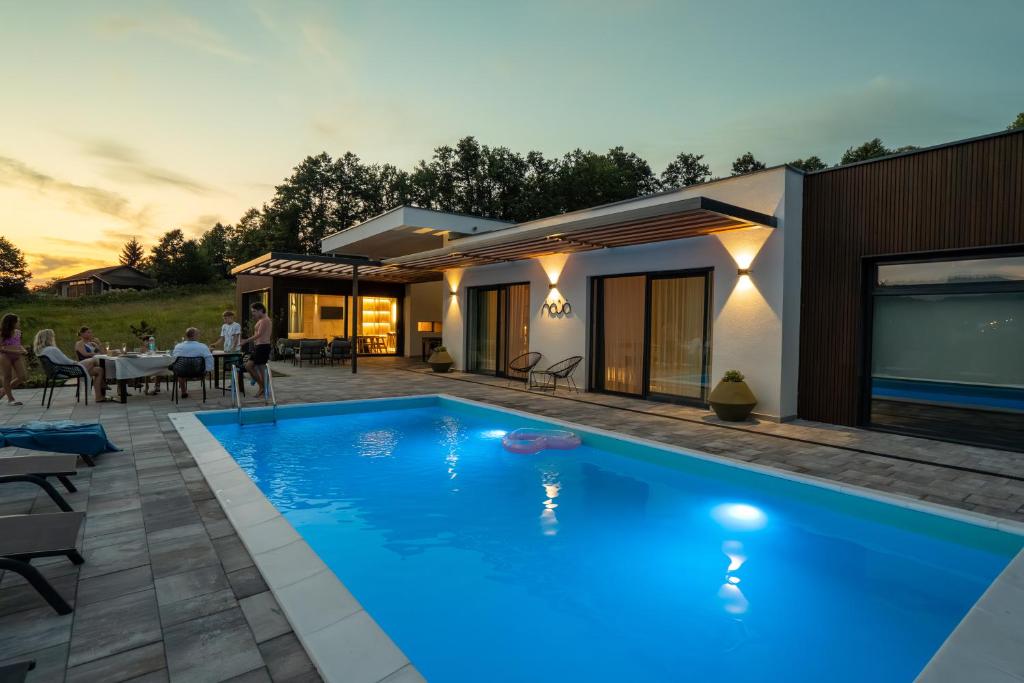 a swimming pool in the backyard of a house at Villa Alma Nova in Laktaši