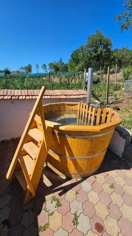 a wooden boat sitting on top of a patio at Casa rustică in Ludoş