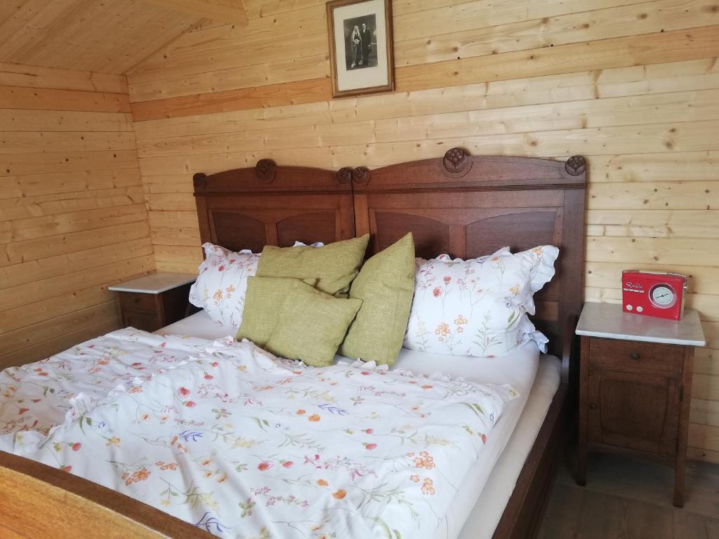 a bedroom with a bed in a log cabin at AlmOtel - Auf der HerziAlm 