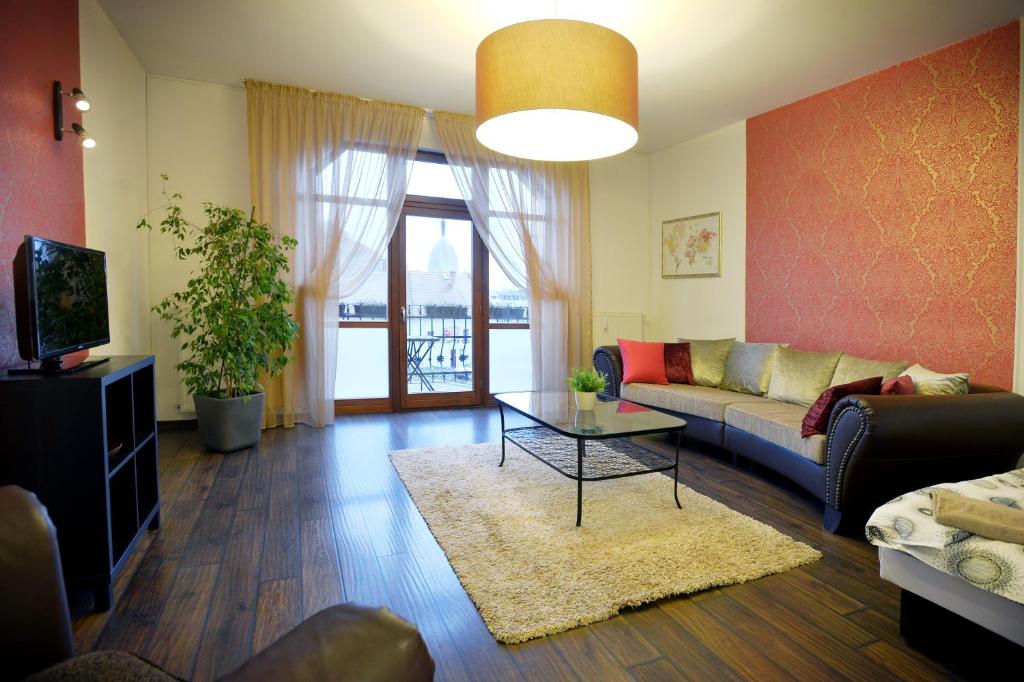 a living room with a couch and a table at Corner Apartman Eger in Eger