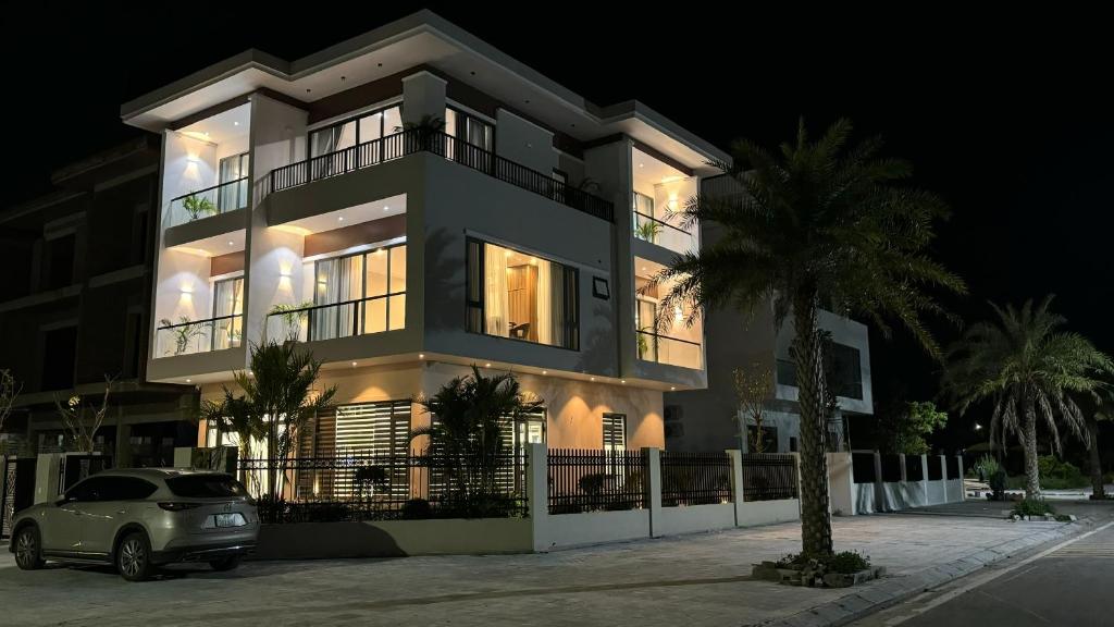 a building with a car parked in front of it at Happy Ocean View Villa in Tài Xá