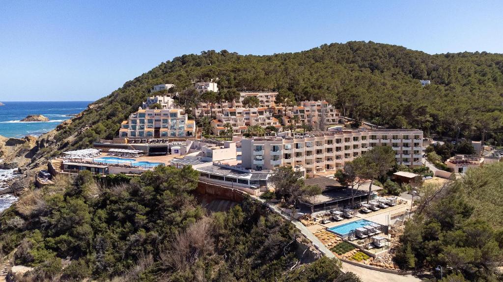 an aerial view of a resort on a hill next to the ocean at Invisa Hotel Club Cala Verde in Es Figueral Beach