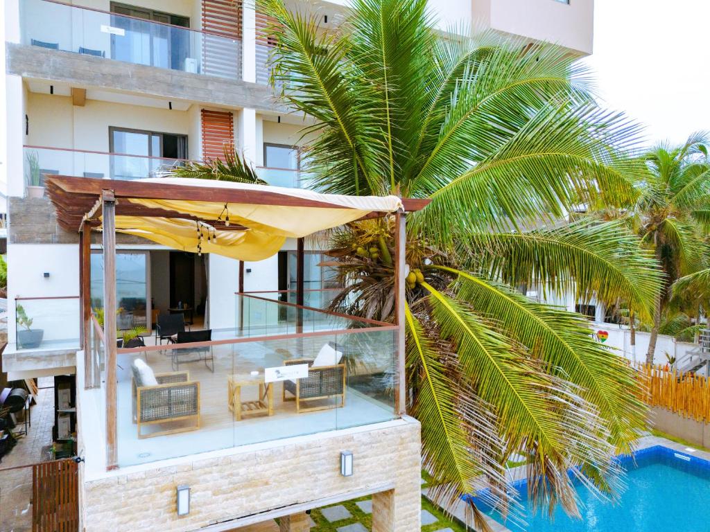 a villa with a swimming pool and a house at Serenity Terraces Beach, Resort in Kokrobite
