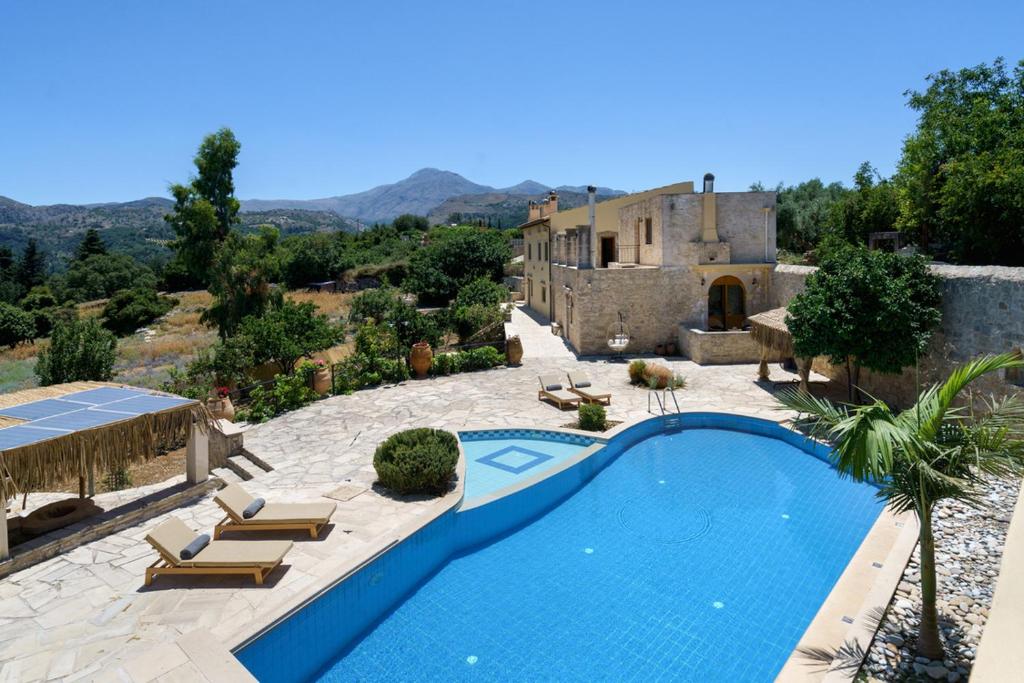 a villa with a swimming pool and a house at New Villa Myre 3, A Family-Friendly Retreat in Crete with Private Pool & 3 Apartments in Zourídhion