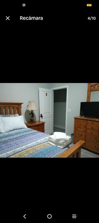 a bedroom with a bed with a dresser and a desk at Beautiful house in quiet place shared bath in Ocala