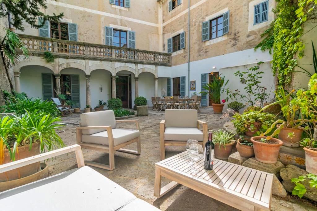 a patio with chairs and tables and a building at Arta - 4337-73 Mallorca in Artá