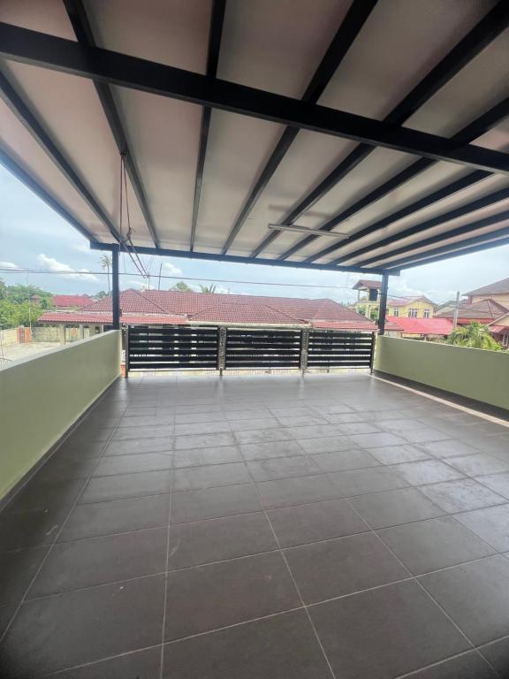 a large empty balcony with a view of a building at Rizqi Homestay Pasir Mas in Pasir Mas