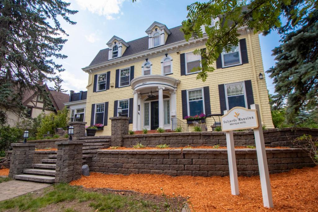 a house with a sign in front of it at Historic Salyards Mansion by Heirloom Boutique Collection in Duluth