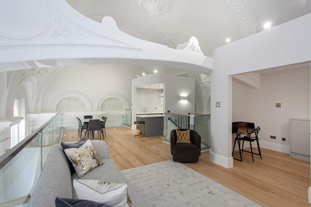 a living room with a couch and a table at Unique City Centre Luxury Three Bed Apartment in Manchester