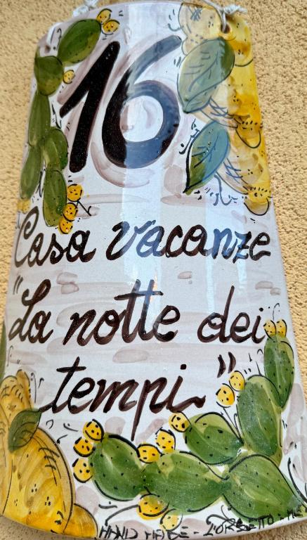 a sign with a number on it with fruit at La notte dei tempi in Scaletta Zanclea