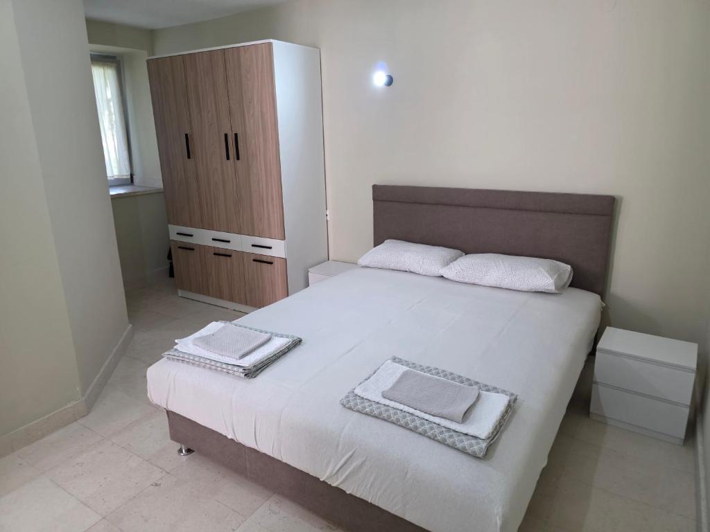 a bedroom with a bed with two towels on it at Apartman SAN, Svetosavska 15 Ljubinje in Ljubinje