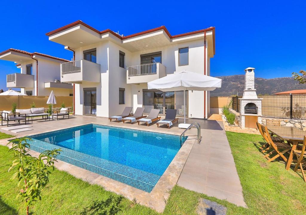 a villa with a swimming pool and a lighthouse at Villa Serenity in Kas