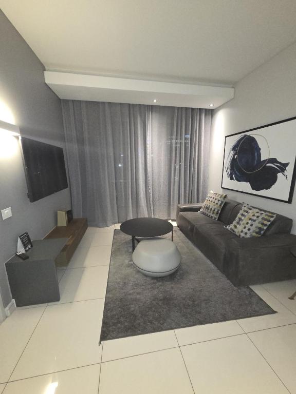 ein Wohnzimmer mit Sofa und Tisch in der Unterkunft ADM Luxury Apartment in Sandton in Johannesburg