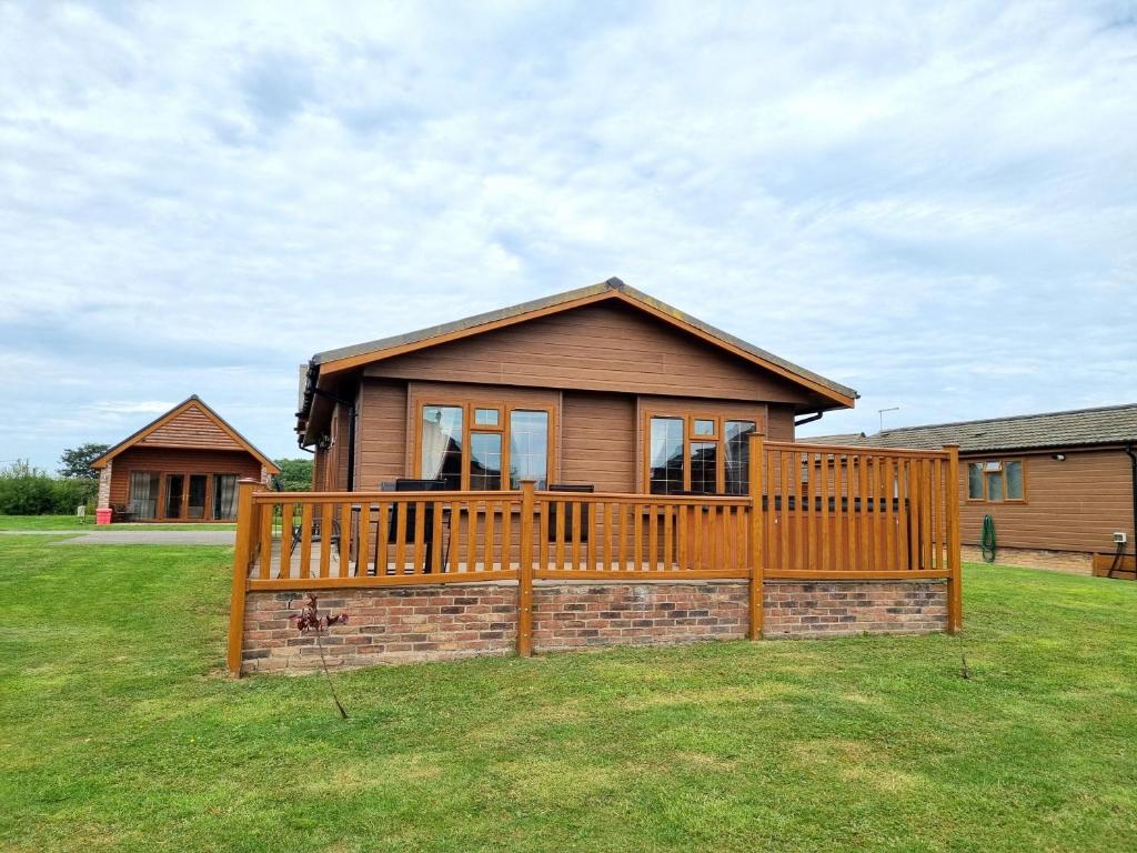 a house with a large deck on a yard at Birch 25 in Garton