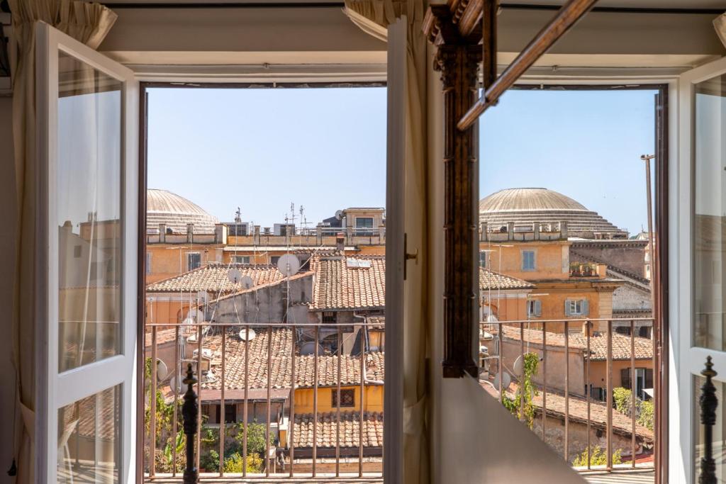 a room with a view of the city from a window at Celeste Retreat al Pantheon - Homkeey Apartments in Rome