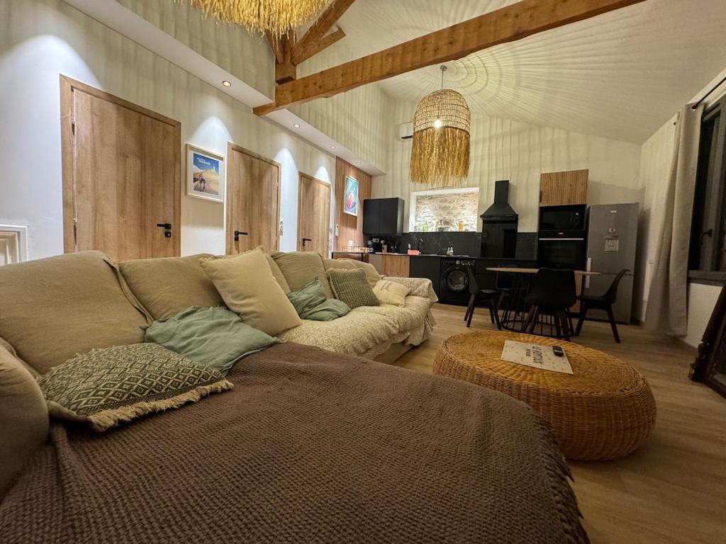 a living room with a couch and a table at La Maison PP - Appartements in Carpentras