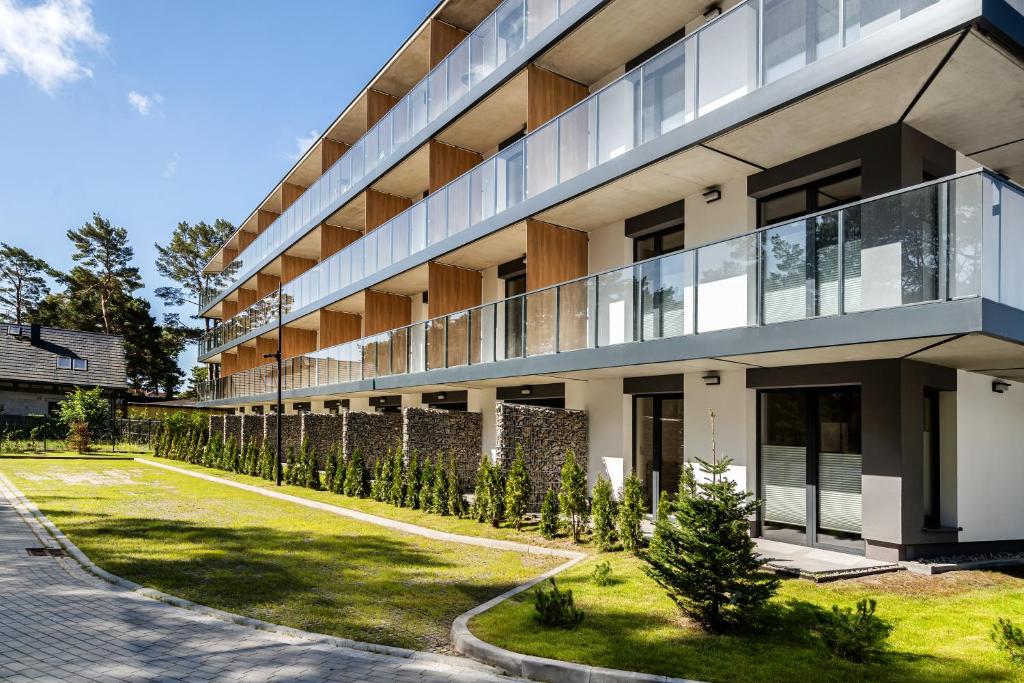 an apartment building with a lawn in front of it at ApartMare in Mrzeżyno