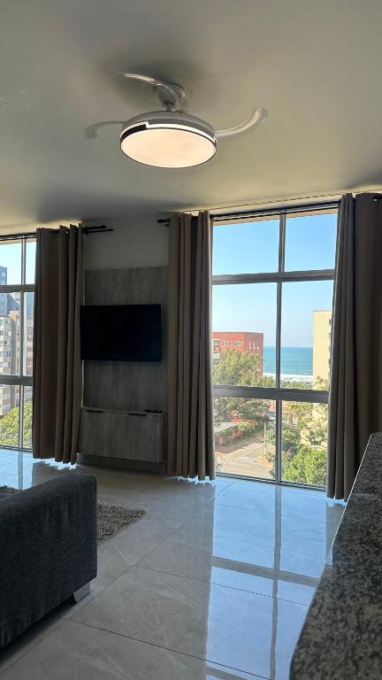 a living room with a large view of the ocean at Modern Ocean-View Apartment in Durban