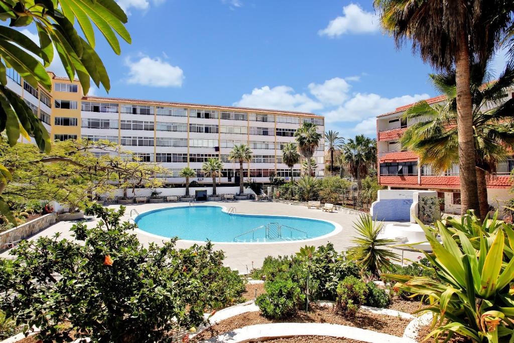 a large swimming pool in front of a building at Chasna in Arona