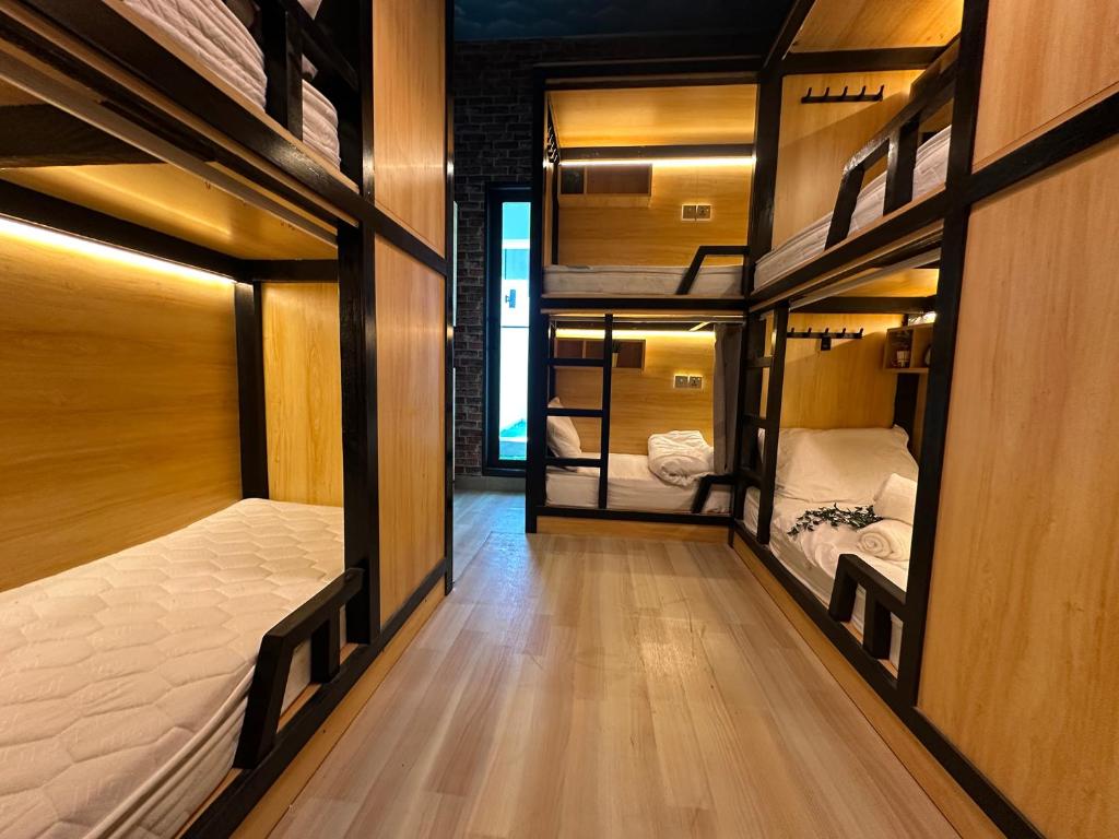 a hallway with three bunk beds in a room at Luxury Hostel Bedspace in Downtown Near Emirates Towers Metro in Dubai