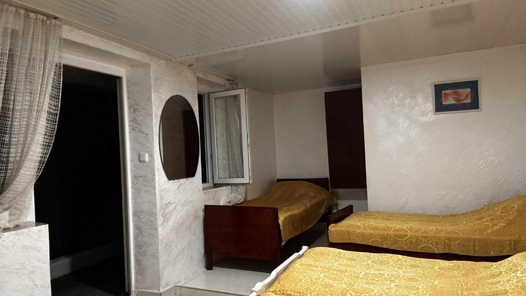 a small room with two beds and a window at tata's house in K'obulet'i