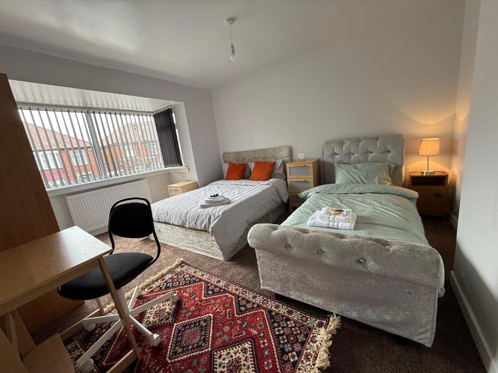 a bedroom with a bed and a couch at Spacious Home Near City Centre in Kenton