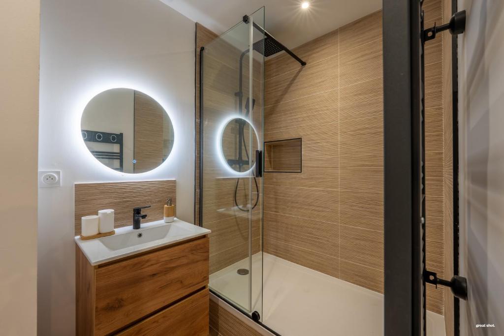 a bathroom with a shower and a sink and a mirror at Chez Mel & Romain in Montauban