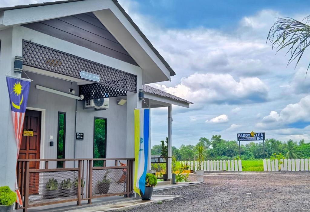 a small white building with a surfboard on it at Paddy Villea with 5 Bedrooms Penang in Permatang Pauh