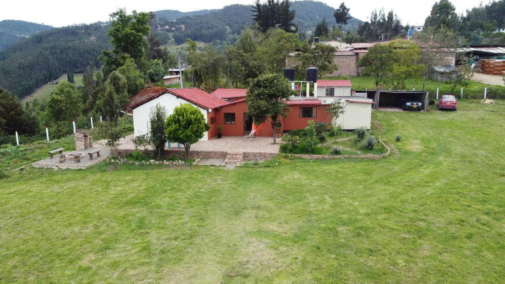 a house in the middle of a green field at Casa de Campo, Excelente Ubicación y Amplias Zonas Verdes in Sogamoso