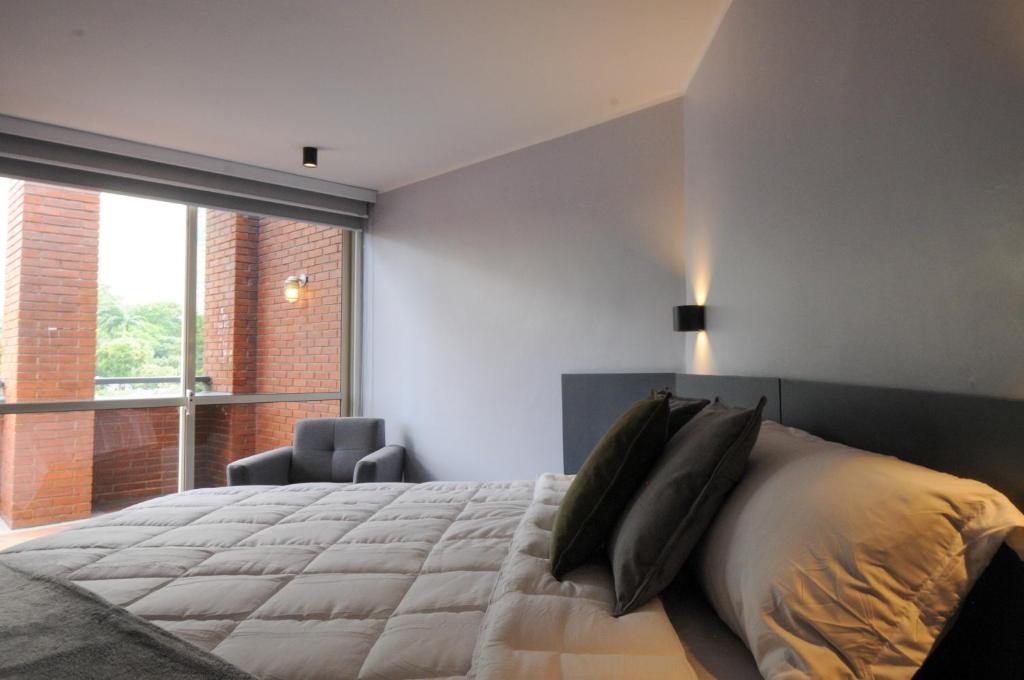 Ένα ή περισσότερα κρεβάτια σε δωμάτιο στο Nomad Suites Altamira