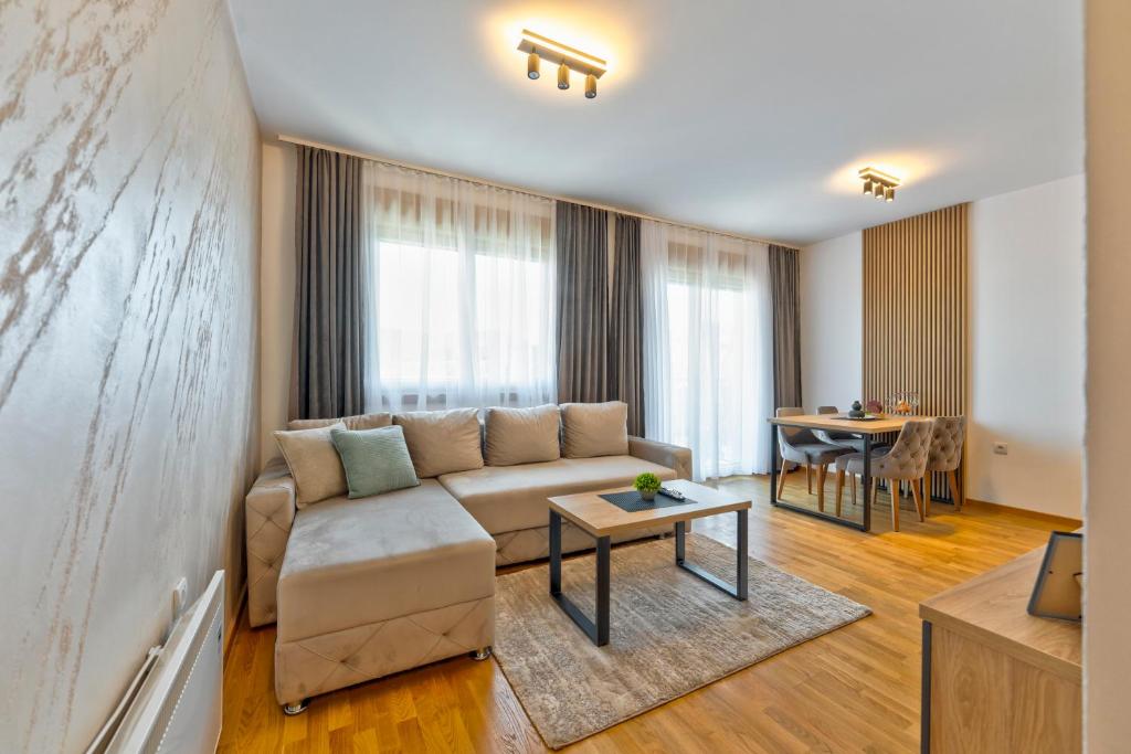 a living room with a couch and a table at Boréa Apartments in Zlatibor
