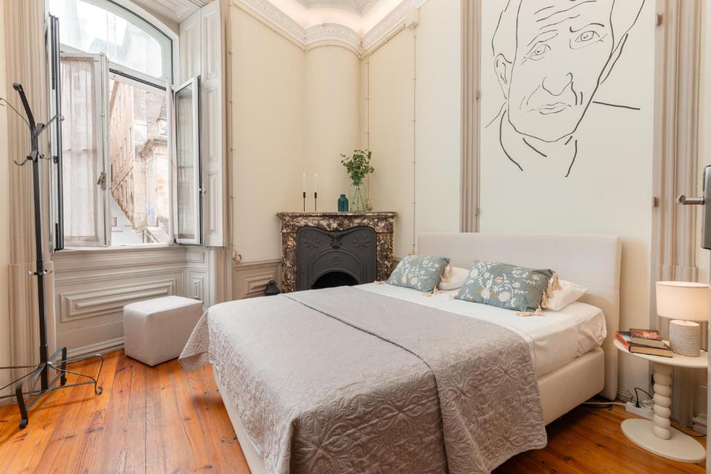 a bedroom with a bed and a drawing on the wall at Serenata Hotel & Hostel Coimbra in Coimbra
